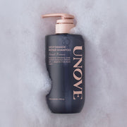 ProtoClinical k-beauty UNOVE DEEP DAMAGE REPAIR SHAMPOO 500ml #Sweet Breeze single upright dark shampoo bottle centered on a soft pink background.