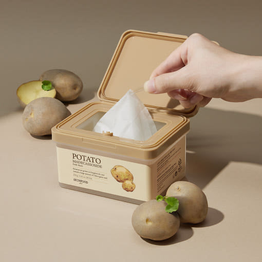 ProtoClinical k-beauty SKINFOOD Potato Madecassoside Daily Mask Sheet 270g/30ea open beige mask tub with one sheet being pulled upward, surrounded by whole potatoes on a tan background