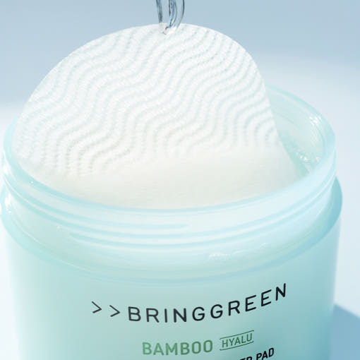 ProtoClinical k-beauty cosmetic packaging in soft beige tones on a pale blue and aqua background.