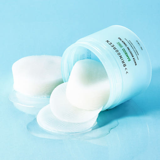ProtoClinical k-beauty white skincare product on a soft aqua background.