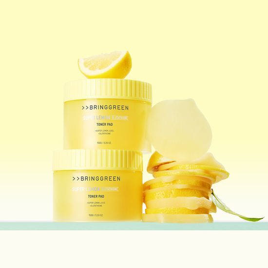 ProtoClinical k-beauty peach and beige cosmetic product packaging on a light background.