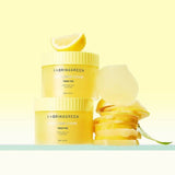 ProtoClinical k-beauty peach and beige cosmetic product packaging on a light background.
