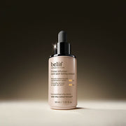 ProtoClinical k-beauty belif Prime Infusion Dark Spot Toning Ampoule 30ml shown as a single taupe ampoule bottle centered on a clean white background with soft lavender side tones