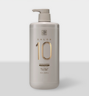 ProtoClinical k-beauty [mise en scene] Salon 10 Protein Shampoo for Extremely Damaged Hair 1150ml beige pump shampoo bottle beside a woman with long dark hair on a warm beige background