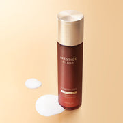 ProtoClinical k-beauty amber-toned cosmetic product packaging with bright yellow side accents on a light background.