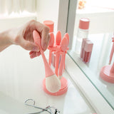 ProtoClinical k-beauty CORINGCO Egg Holder Brush Set 5P beauty tool set with five makeup brushes and a rounded egg-shaped holder on a light background