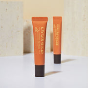 ProtoClinical k-beauty ETUDE Ginger Sugar Essential Lip Balm 15ml single brown lip balm tube centered on a warm peach background with a pale blue lower band