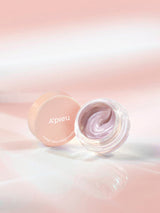 ProtoClinical k-beauty A'pieu Juicy Pang Glossy Jelly Highlighter 3.8g (2 Colors) open clear jar with pearly mauve jelly, pink lid beside it on a soft peach gradient background
