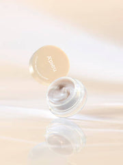 ProtoClinical k-beauty A'pieu Juicy Pang Glossy Jelly Highlighter 3.8g (2 Colors) open clear jar with pearly ivory jelly, pale yellow lid above it on a warm cream gradient background