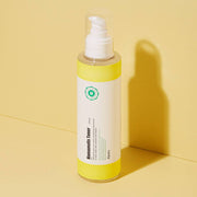 ProtoClinical k-beauty A'pieu Hamamelis Toner 200ml single upright amber toner bottle centered on a warm golden background