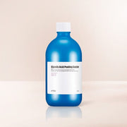 ProtoClinical k-beauty tall blue product packaging centered on a peach and cream background.