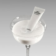 ProtoClinical k-beauty beplain Milk Ceramide Lip Essence 10g white squeeze tube resting in a clear glass dish filled with milky white essence on a light gray background