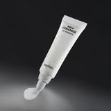 ProtoClinical k-beauty beplain Milk Ceramide Lip Essence 10g white squeeze tube angled above a glossy clear balm swatch on a dark charcoal background
