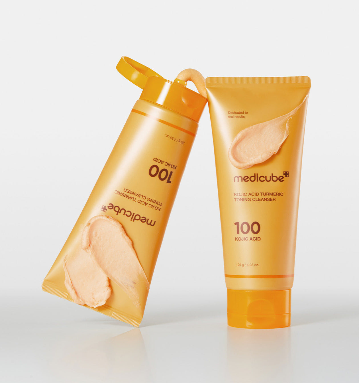 ProtoClinical k-beauty MEDICUBE: Kojic Acid Turmeric Toning Cleanser (120g), single upright golden yellow cleanser tube on a white background.