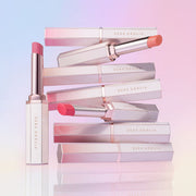 ProtoClinical k-beauty [DEAR DAHLIA] Lip Allure Glow Shine 2.4g (8colors) single upright pink lip product centered on a pale lilac and white background