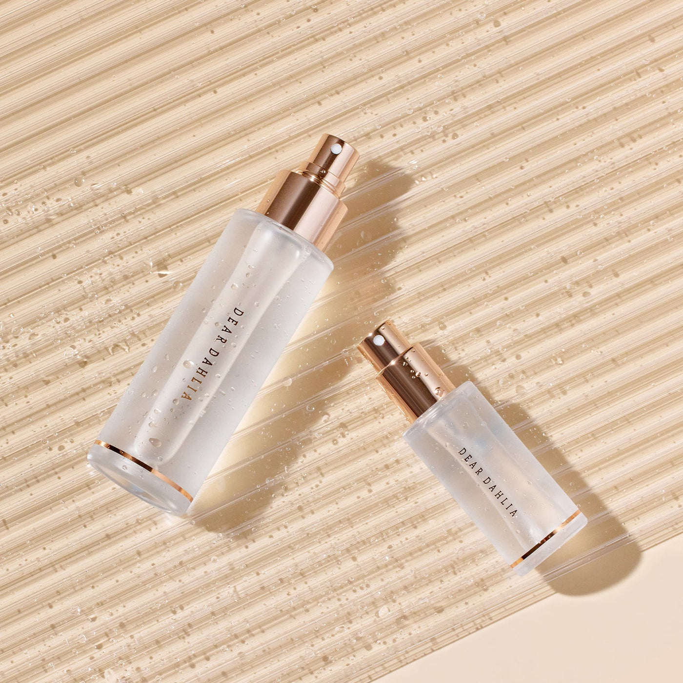ProtoClinical k-beauty [DEAR DAHLIA] Endless Skin Setting Spray 30ml slim beige skincare bottle on a light background with warm neutral tones