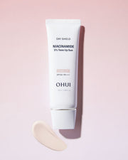 ProtoClinical k-beauty blush-beige beauty product with a darker vertical center on a soft gradient background.