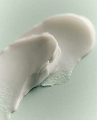 ProtoClinical k-beauty muted brown beauty graphic with a centered rectangular silhouette and soft aqua edges.