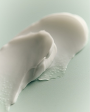 ProtoClinical k-beauty muted brown beauty graphic with a centered rectangular silhouette and soft aqua edges.
