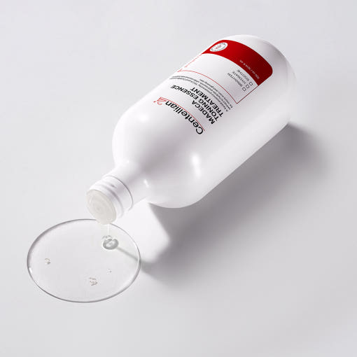 ProtoClinical k-beauty CENTELLIAN24 Toning Essence Treatment 300ml white treatment bottle lying on its side with a red label and clear liquid pooled on a white background