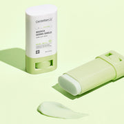 ProtoClinical k-beauty CENTELLIAN24 Madeca Derma Shield Safe Sun Stick SPF50+ PA++++ 18g with one upright white-and-green stick, one uncapped balm laid flat, and a translucent swatch on a pale green background