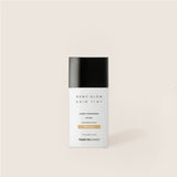 ProtoClinical k-beauty warm beige beauty bottle silhouette with a charcoal cap on a soft ivory background.
