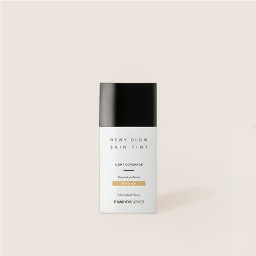 ProtoClinical k-beauty warm beige beauty bottle silhouette with a charcoal cap on a soft ivory background.