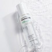 ProtoClinical k-beauty [NATURE REPUBLIC] The First Niacinamide Treatment Essence 150ml shown as a single centered gray bottle silhouette on a pale blue background with soft white side shading