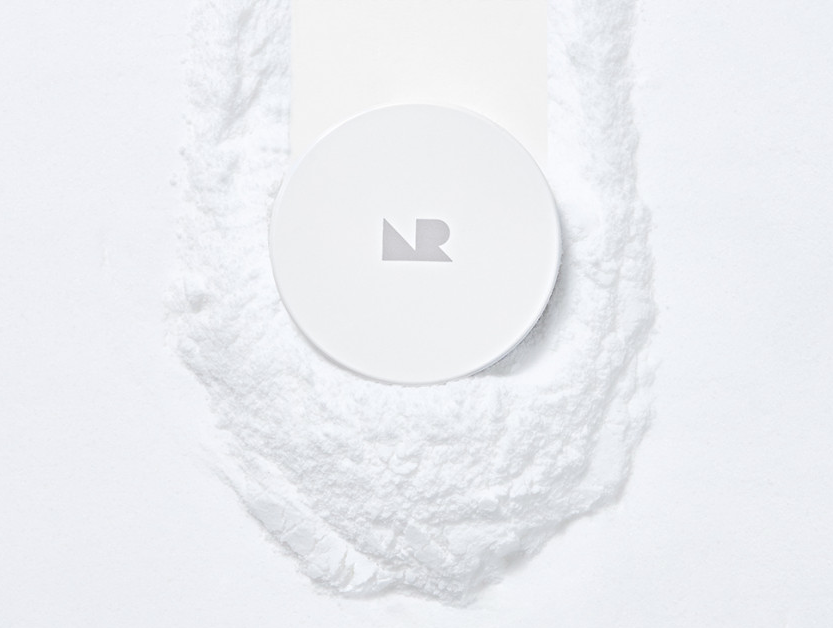 ProtoClinical k-beauty [NATURE REPUBLIC] No-Sebum Finish Powder 4g as a soft blue rectangular powder case with a gray lower block centered on a light background
