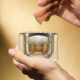 ProtoClinical k-beauty warm yellow beauty product detail with soft brown tones on a light background.