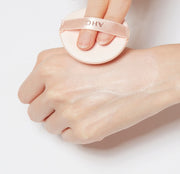 ProtoClinical k-beauty AHC Aura Secret Tone Up Cushion SPF30 PA++ 15g white round puff pressed to the back of a hand with a glossy swatch on a pale background