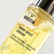 ProtoClinical k-beauty ROVECTIN Vita Brightening Dark Spot Serum 30ml abstract beauty graphic with muted mauve on the left and warm yellow tones on a light background.