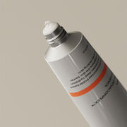 ProtoClinical k-beauty product packaging photo with a muted dark center on a light background.