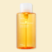 ProtoClinical k-beauty Shingmulnara Calendula Calming Toner 500ml in a single centered upright packshot with warm golden tones and soft cream side shading on a light background