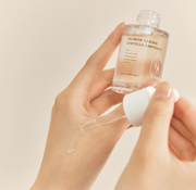 ProtoClinical k-beauty HEVEBLUE Salmon Caring Centella Ampoule 30ml single upright taupe ampoule bottle centered on a pale blue background with soft blue side panels.