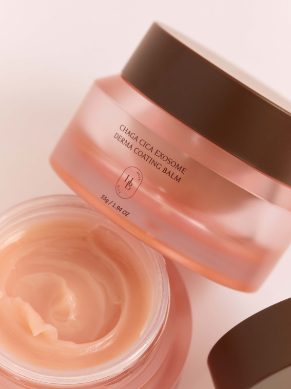 ProtoClinical k-beauty HEVEBLUE Chaga Cica Exosome Derma Coating Balm 55g close-up of a translucent pink balm jar with a brown lid beside an open jar showing cream on a pale background