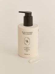 HEVEBLUE Black Yuja Bean Milk Cleanser 290ml by ProtoClinical shown in product packaging with a dark rounded form and soft beige side panels on a light background for a k-beauty skincare routine.