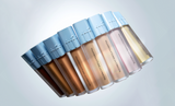 ProtoClinical k-beauty tfit Buildable Fit Spatula Foundation 15g (7colors) shown as seven foundation bottles in a diagonal row with sky-blue caps and varying shade tones on a pale blue background