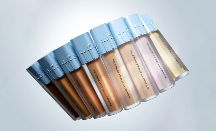 ProtoClinical k-beauty tfit Buildable Fit Spatula Foundation 15g (7colors) shown as seven foundation bottles in a diagonal row with sky-blue caps and varying shade tones on a pale blue background