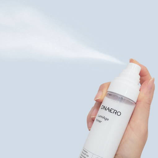 ProtoClinical k-beauty bravity DNAERO LumiAge Toner 100ml shown as a single light gray bottle upright and centered on a soft white background