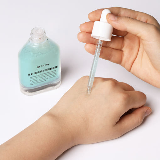 ProtoClinical k-beauty beige and mauve beauty product packaging on a light background.
