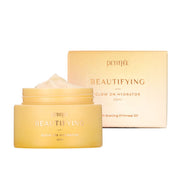ProtoClinical k-beauty PETITFEE Beautifying Glow On Hydrator 50ml multiple warm peach hydrator packages side by side on a pale background with light blue corner accents