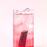 ProtoClinical k-beauty pink beauty product silhouette with a deep rose center on a light background.