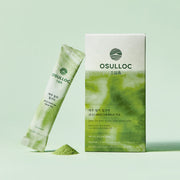 ProtoClinical k-beauty pale green beauty product silhouette with an olive center on a pale blue background.