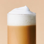 ProtoClinical k-beauty cream beauty detail with a dark brown lower-right form on a warm beige background.