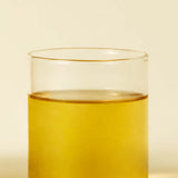 ProtoClinical k-beauty pale yellow beauty detail with soft blue and cream tones on a light background.
