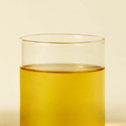 ProtoClinical k-beauty pale yellow beauty detail with soft blue and cream tones on a light background.