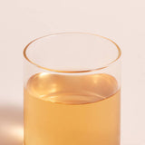 ProtoClinical k-beauty warm orange beauty detail with soft blue side accents on a light background.