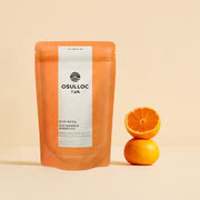 ProtoClinical k-beauty peach beauty detail with warm orange tones on a pale pink background.