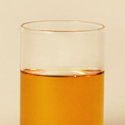ProtoClinical k-beauty peach beauty product detail on a pale yellow background.